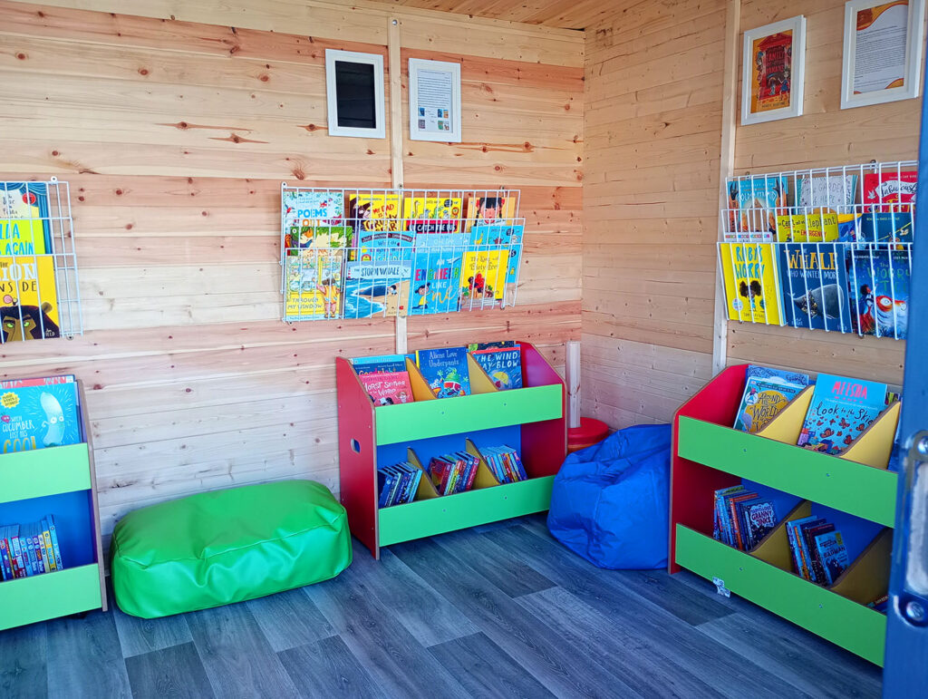 literacy shed interior colourful book shelves and childrens bean bags