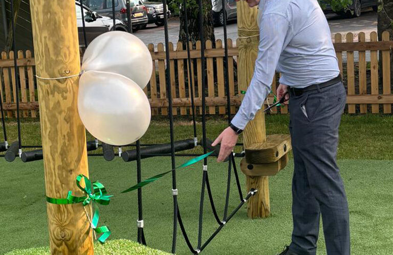 Guest of Honor Andrew Jones MCBF Chair cuts the ribbon at the grand opening of the new playgound